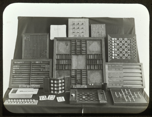 Display of tactile table games for the blind including Tic-tac-toe, Back-gammon, Dominoes, 5-Pair, Checkers, Halma, Authors, Parchesi, Chess, Thirty-one, and Solitair